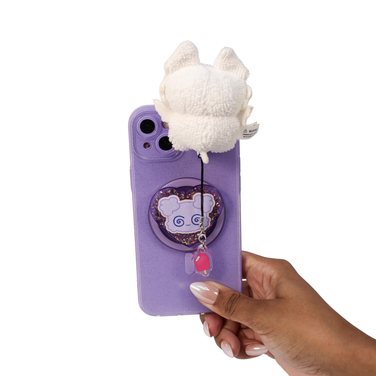 A hand holding a light purple phone case decorated with a white Wispeez™ plush bat charm and a dangling pink bead, against a plain white background.